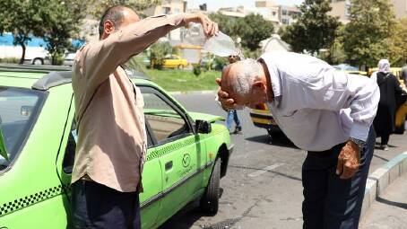 Taxi drivers cool off during the hot weather in Tehran, where the mercury has gone as high as 42C. Photo: EPA PHOTO